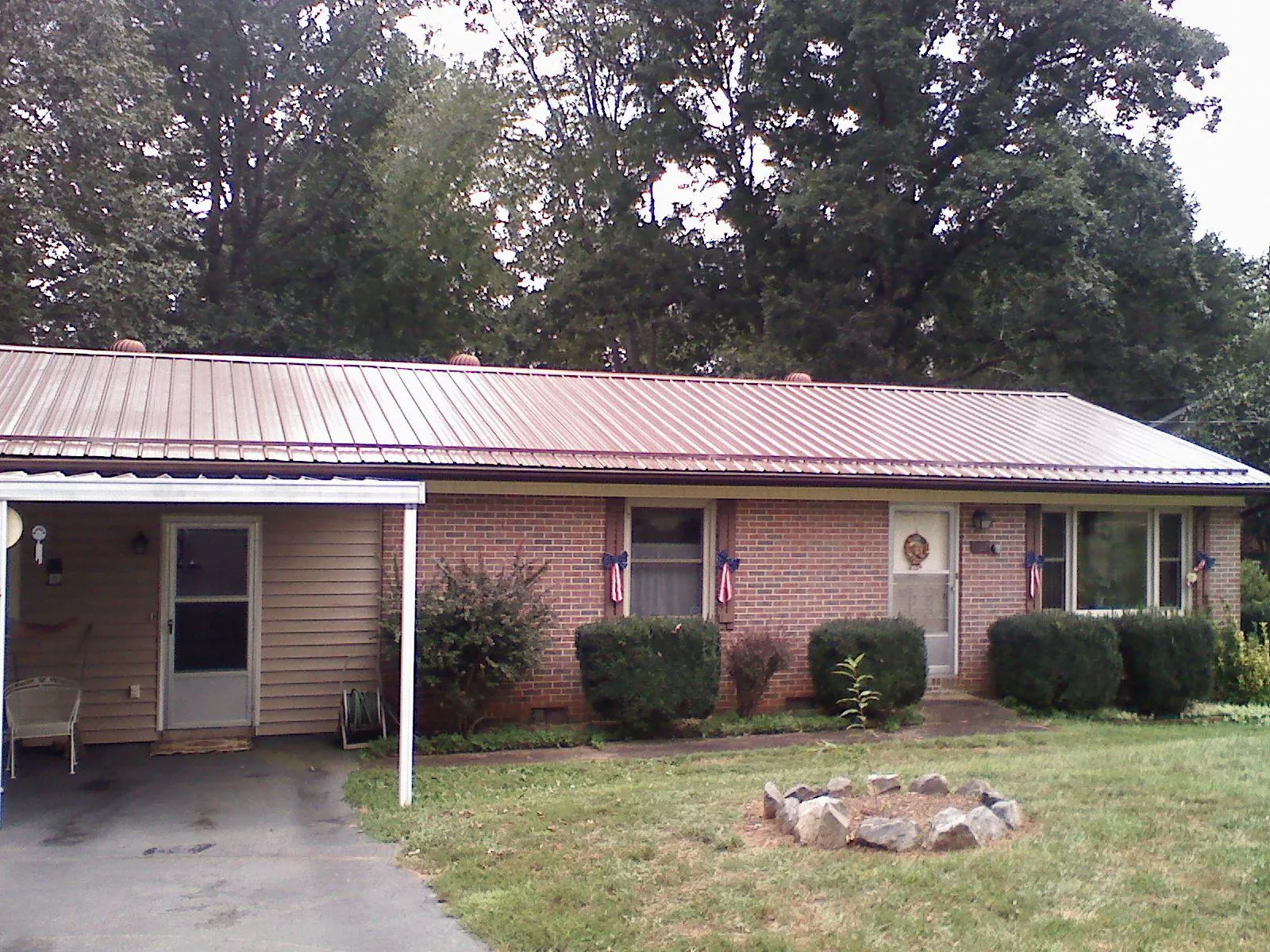 Bronze metal roof and carport on a brick ranch home — Roof Repair work by our crew in Landisville